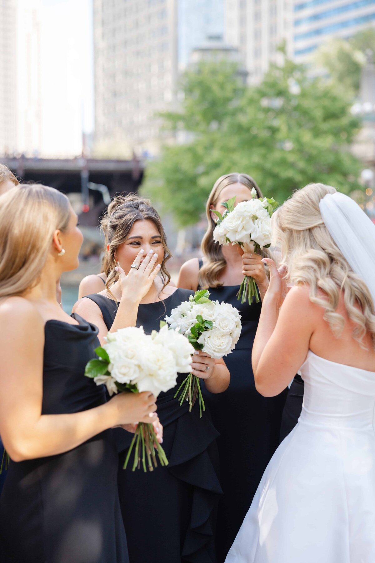 Ivory rose bouquets carried by the bridal party at a Saint James Chapel wedding